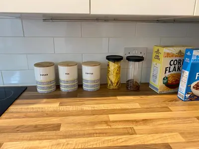 a group of five jars on a kitchen counter with food at Merseyside in Birkenhead