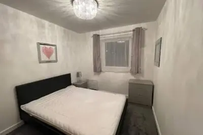 a bedroom with a white bed and a window at Moda Wigan 2 - Stylish 2 Bed in Central Wigan in Wigan