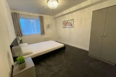 a bedroom with a bed and a window in it at Moda Wigan 2 - Stylish 2 Bed in Central Wigan in Wigan