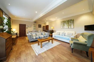 a living room with two couches and a tv at Cadshaw Country Views in Darwen