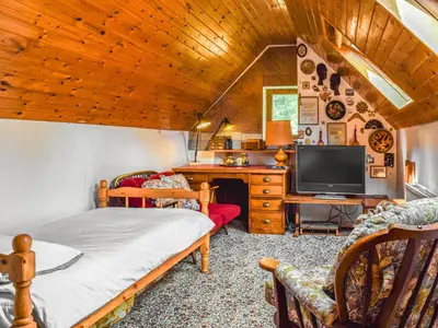 a bedroom with a bed and a desk with a tv at Court House in Halsall