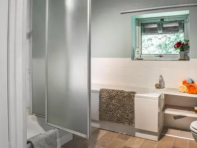 a bathroom with a shower and a bath tub at Court House in Halsall