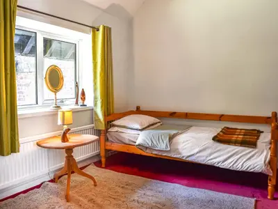 a bedroom with a bed and a mirror and a window at Court House in Halsall