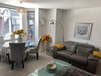 a living room with a couch and a table at Kensington Luxury Apartment on Gated Development in Leafy edge of Chorley Town Centre in Chorley
