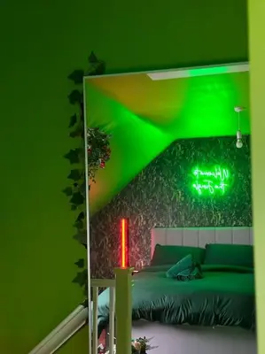 a green bedroom with a bed and a green wall at #1 Most Viral Pink House w Ball Pit in Liverpool