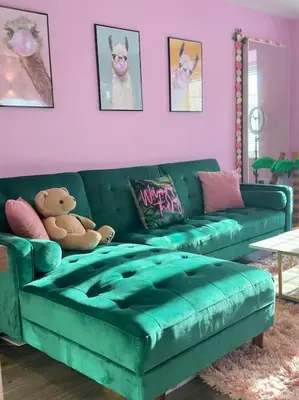 a green couch in a living room with a teddy bear at #1 Most Viral Pink House w Ball Pit in Liverpool
