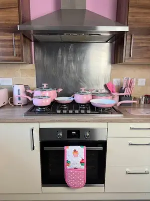 a kitchen with pink pots and pans on a stove at #1 Most Viral Pink House w Ball Pit in Liverpool