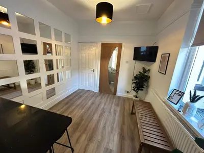 a large living room with a table and a window at Westview House by Sasco Apartments in Blackpool