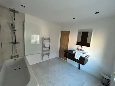 a bathroom with a bath tub and a sink and a bath tub at Westview House by Sasco Apartments in Blackpool