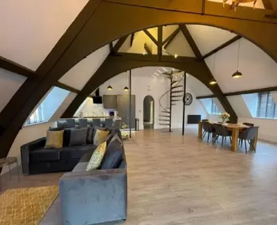 a living room with a couch and a table at Central Luxurious Stylish Church Conversion in Blackpool