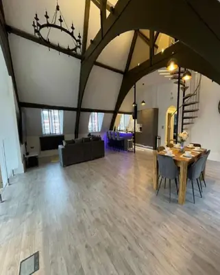 a large room with a table and chairs in it at Central Luxurious Stylish Church Conversion in Blackpool