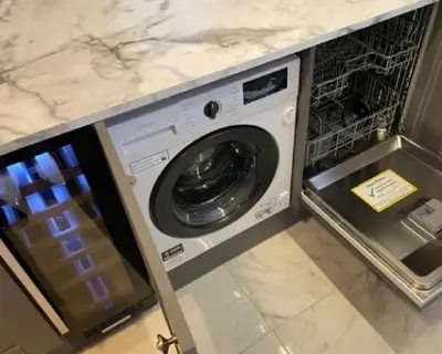 a washer and dryer sitting in a kitchen at Central Luxurious Stylish Church Conversion in Blackpool