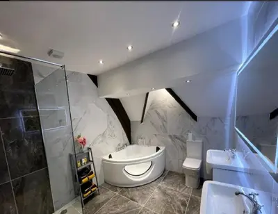 a bathroom with a sink and a toilet and a shower at Central Luxurious Stylish Church Conversion in Blackpool
