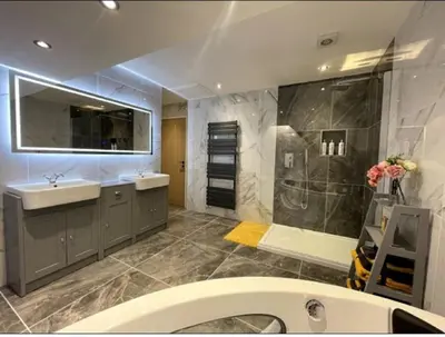 a bathroom with a sink and a shower at Central Luxurious Stylish Church Conversion in Blackpool