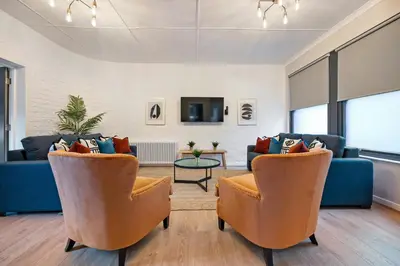 a living room with two chairs and a couch at Host & Stay - The Coachouse at Pilgrim St in Liverpool