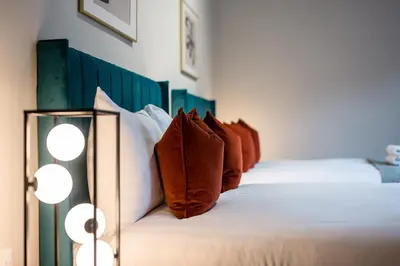 a bedroom with a bed with red and white pillows at Host & Stay - The Coachouse at Pilgrim St in Liverpool