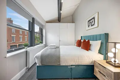 a bedroom with a bed and a large window at Host & Stay - The Coachouse at Pilgrim St in Liverpool
