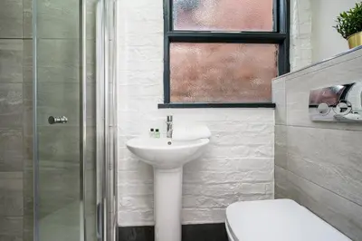 a bathroom with a sink and a toilet and a shower at Host & Stay - The Coachouse at Pilgrim St in Liverpool