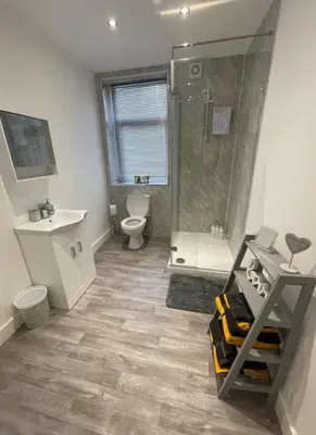 a bathroom with a shower and a toilet and a sink at Newly Refurbished Clarendon Apartments, Free WIFI, Parking in Blackpool