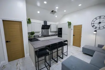 a kitchen and living room with a bar and a couch at Cozy Charming Bungalow BRAND NEW in Preston