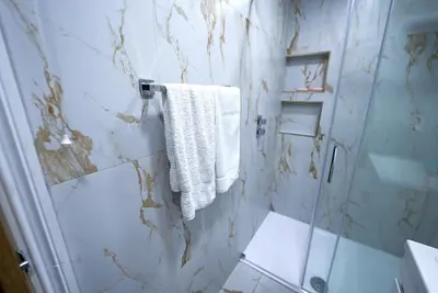 a bathroom with a shower and a white towel at Cozy Charming Bungalow BRAND NEW in Preston