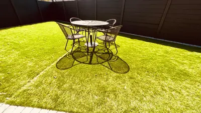a table and two chairs on a patch of grass at Cozy Charming Bungalow BRAND NEW in Preston
