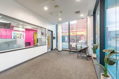 an office space with a table and chairs and windows at For Students Only Glassworks in Liverpool in Liverpool