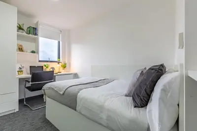 a bedroom with a bed and a desk with a computer at For Students Only Glassworks in Liverpool in Liverpool