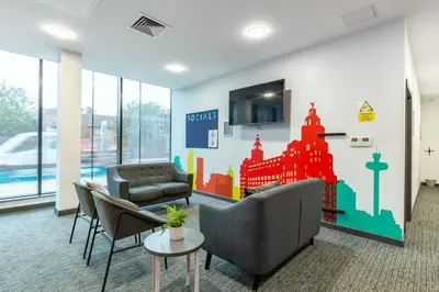 a lobby with a waiting room with a couch and chairs at For Students Only Glassworks in Liverpool in Liverpool