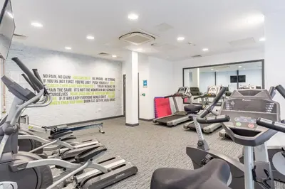 a gym with treadmills and elliptical machines at For Students Only Glassworks in Liverpool in Liverpool