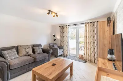 a living room with a couch and a table at 1 The Cottage in Upholland