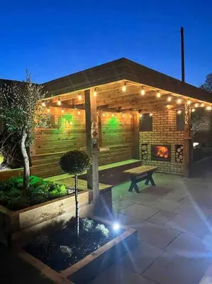 a house with a bench and a fireplace at 1 The Cottage in Upholland