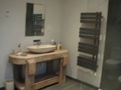 a bathroom with a sink and a mirror at Farriers Fold in Grange Over Sands