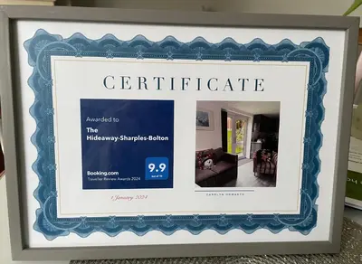 a framed picture of a certificate in a room at The Hideaway-Sharples-Bolton in Bolton
