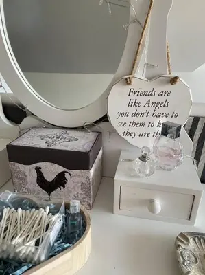 a table with a mirror and a box with a sign at The Hideaway-Sharples-Bolton in Bolton