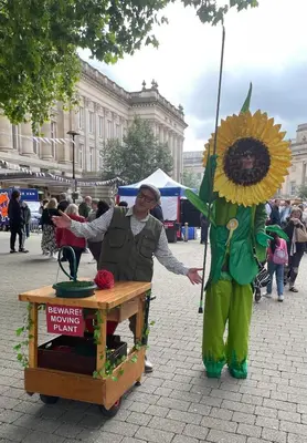 a woman standing next to a person dressed in a sunflower at The Hideaway-Sharples-Bolton in Bolton