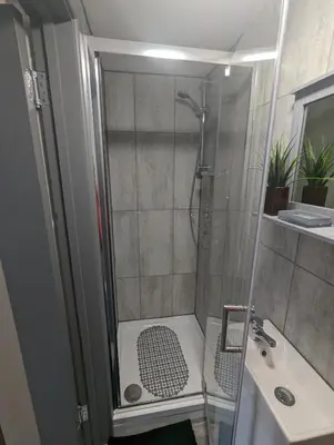a bathroom with a shower and a sink at Station Apartments in Ashton in Makerfield
