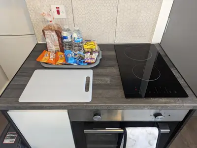 a kitchen with a counter top with a laptop on it at Station Apartments in Ashton in Makerfield