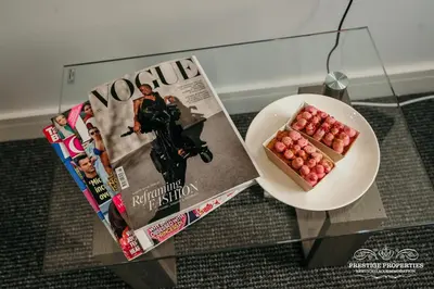 a plate of apples on a table next to a magazine at Dover St by Prestige Properties SA in Barrow in Furness