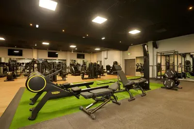 a gym with several treadmills and machines in it at Park hall Hotel & Spa Lancashire, a member of Radisson Individuals in Eccleston