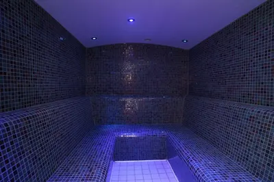 a blue room with a tub with blue lights in it at Park hall Hotel & Spa Lancashire, a member of Radisson Individuals in Eccleston