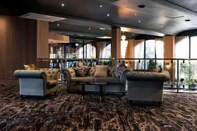 a lobby with couches and tables in a room at Park hall Hotel & Spa Lancashire, a member of Radisson Individuals in Eccleston