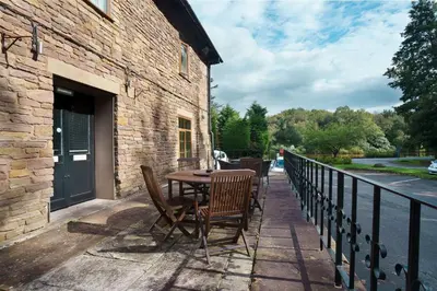 a patio with a table and chairs on a balcony at Park hall Hotel & Spa Lancashire, a member of Radisson Individuals in Eccleston