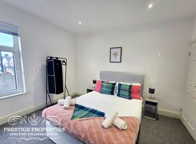 a bedroom with a bed and a window at Warwick St by Prestige Properties SA in Barrow in Furness