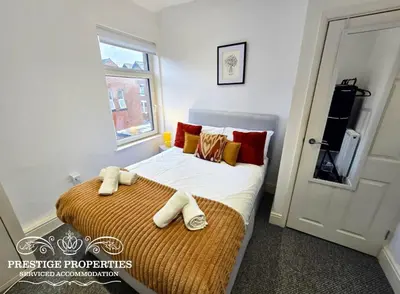 a bedroom with a bed with two towels on it at Warwick St by Prestige Properties SA in Barrow in Furness