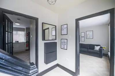 a mirror reflection of a living room with a couch at Poppy's Place - Manningham Road in Liverpool