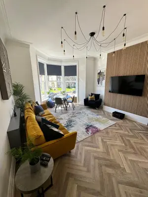 a living room with a yellow couch and a tv at No 3 ,luxury 2 bed 1st floor apartment with free parking,Lytham St Annes in Saint Annes on the Sea