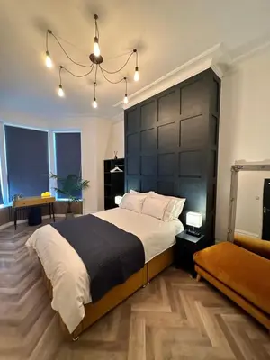 a bedroom with a large bed with a black headboard at No 3 ,luxury 2 bed 1st floor apartment with free parking,Lytham St Annes in Saint Annes on the Sea