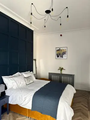 a bedroom with a large bed with a black headboard at No 3 ,luxury 2 bed 1st floor apartment with free parking,Lytham St Annes in Saint Annes on the Sea