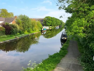 a boat is parked on the side of a canal at Briar Cottage in Great Eccleston